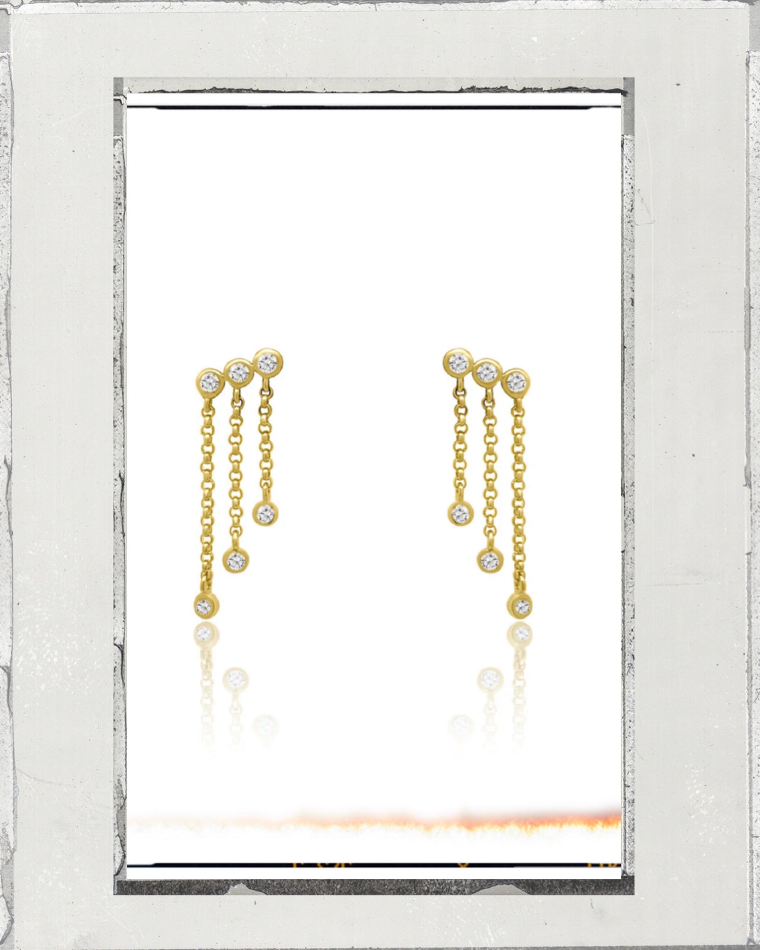 Two small gold hoop earrings with pointed spikes.