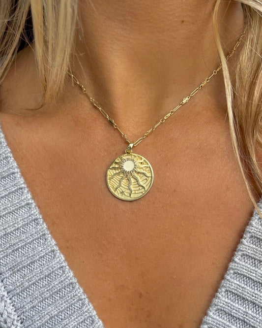 gold filled chain with gold plated silver sun rays pendant with enamel and diamond surrounding the sun