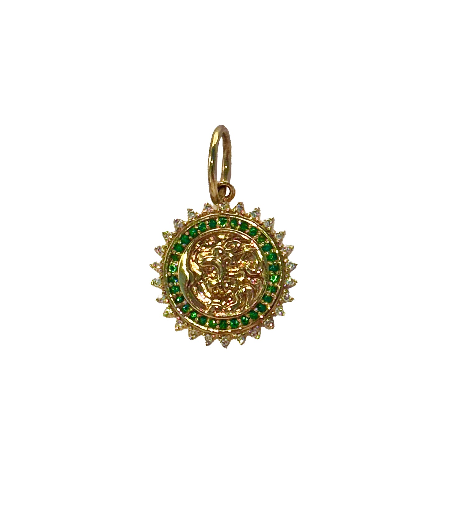 The AIRA FIERCE Gold Diamond Emerald Charm is a gold and green sun pendant with a detailed face design, sparkling diamonds, emeralds, and a loop for chain attachment.