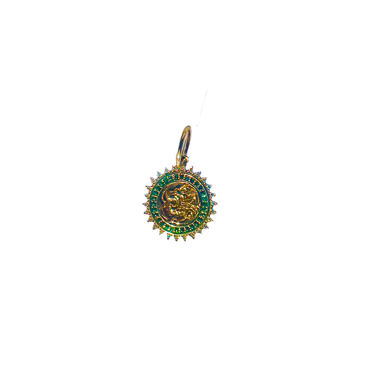 The FIERCE Gold Diamond Emerald Charm by AIRA is a round yellow gold pendant with a vibrant green trim, featuring an intricate lion design adorned with dazzling emeralds.