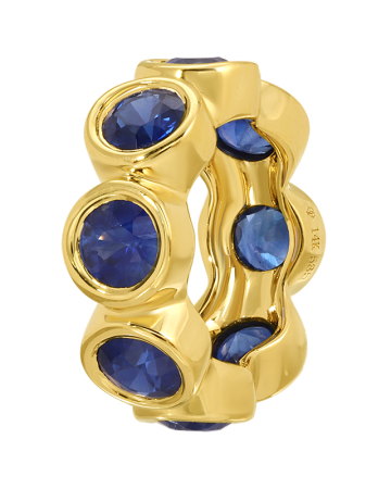 Gold ring with blue gemstones on a white background