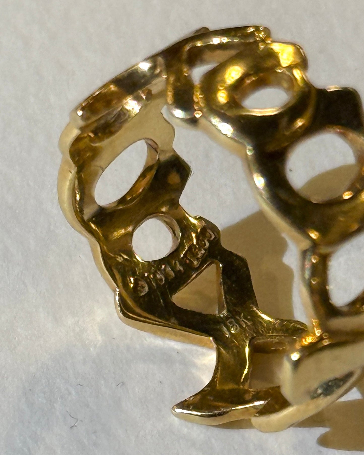 Gold ring with a design of a person on a horse on a white background