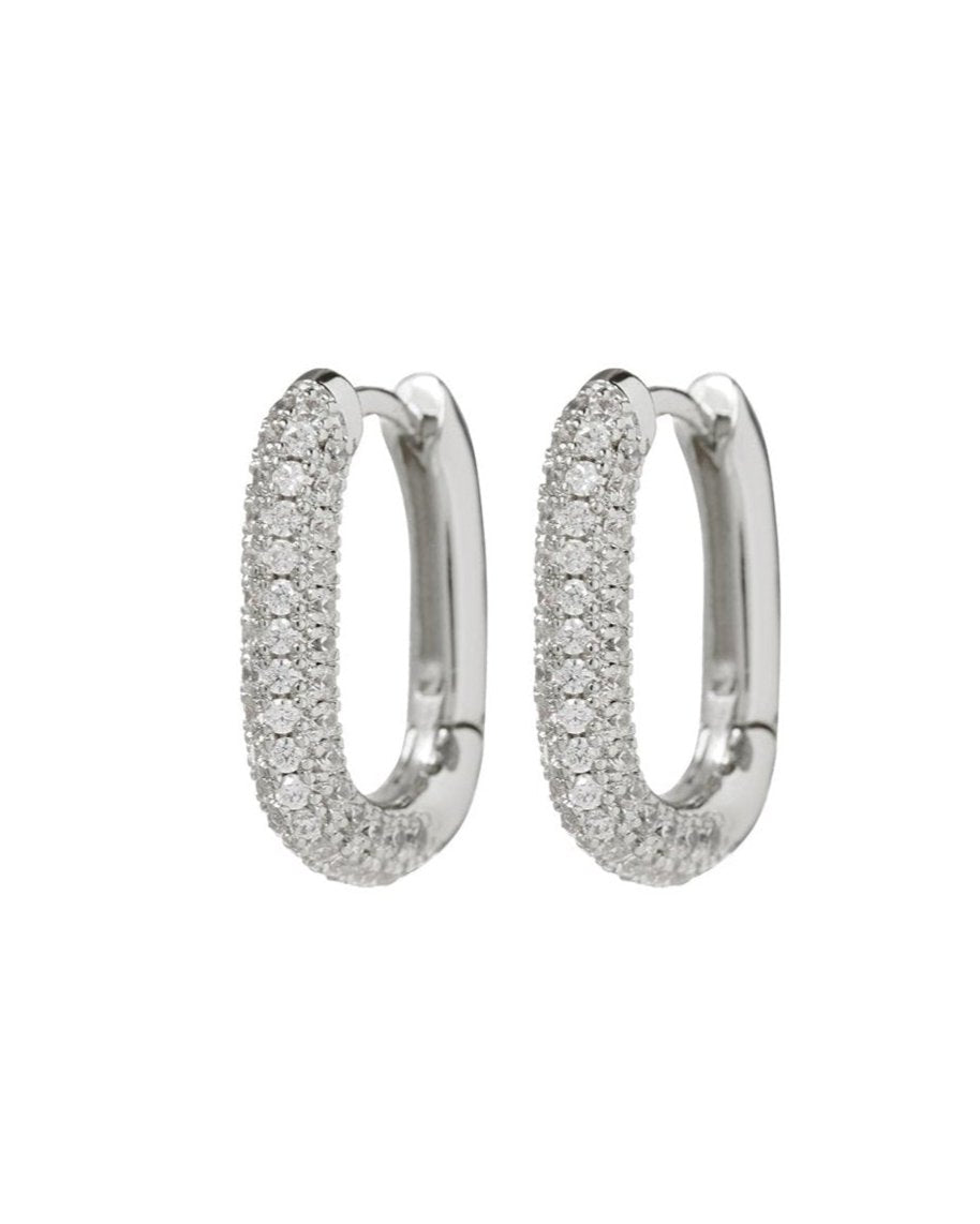 The JESS Huggies by Luv AJ are elegant oval-shaped hoops, gold-plated and beautifully encrusted with small cubic zirconia stones.