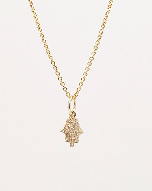 gold chain with gold and diamond hamsa charm  @dylanjamesjewelry.com