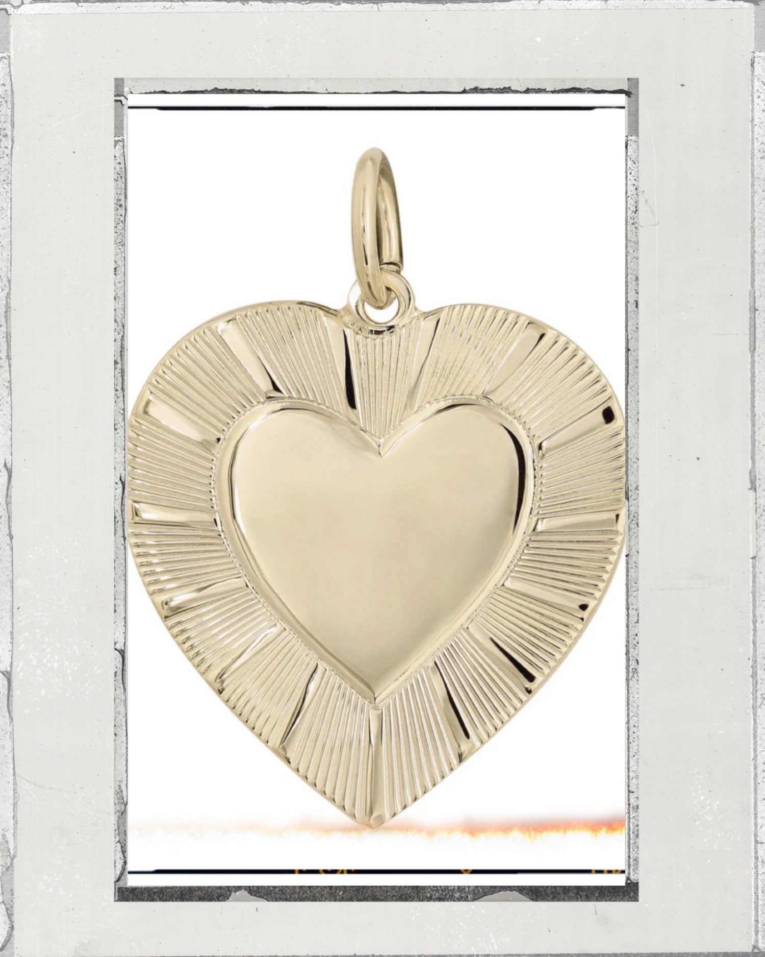 A gold chain necklace with a large pendant featuring a square gold plate and a blue heart-shaped stone in the center.