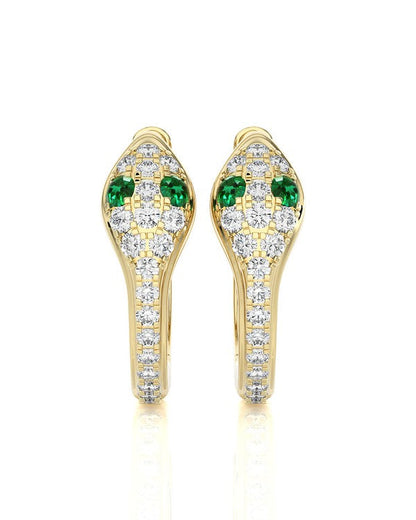A pair of gold snake-head stud earrings set with green emerald-cut stones and pavé diamonds on a white background.