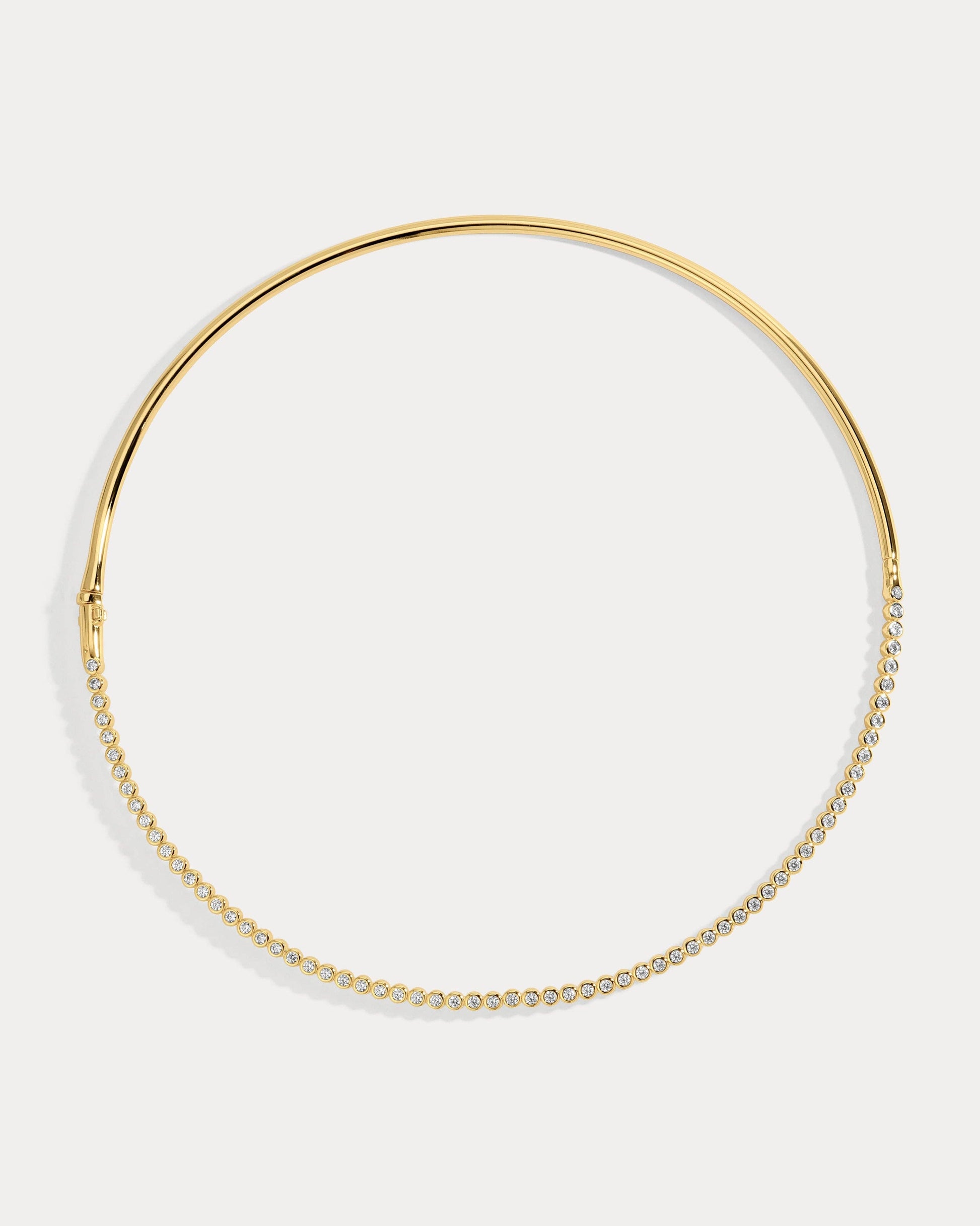 Gold hoop collar necklace on a white background