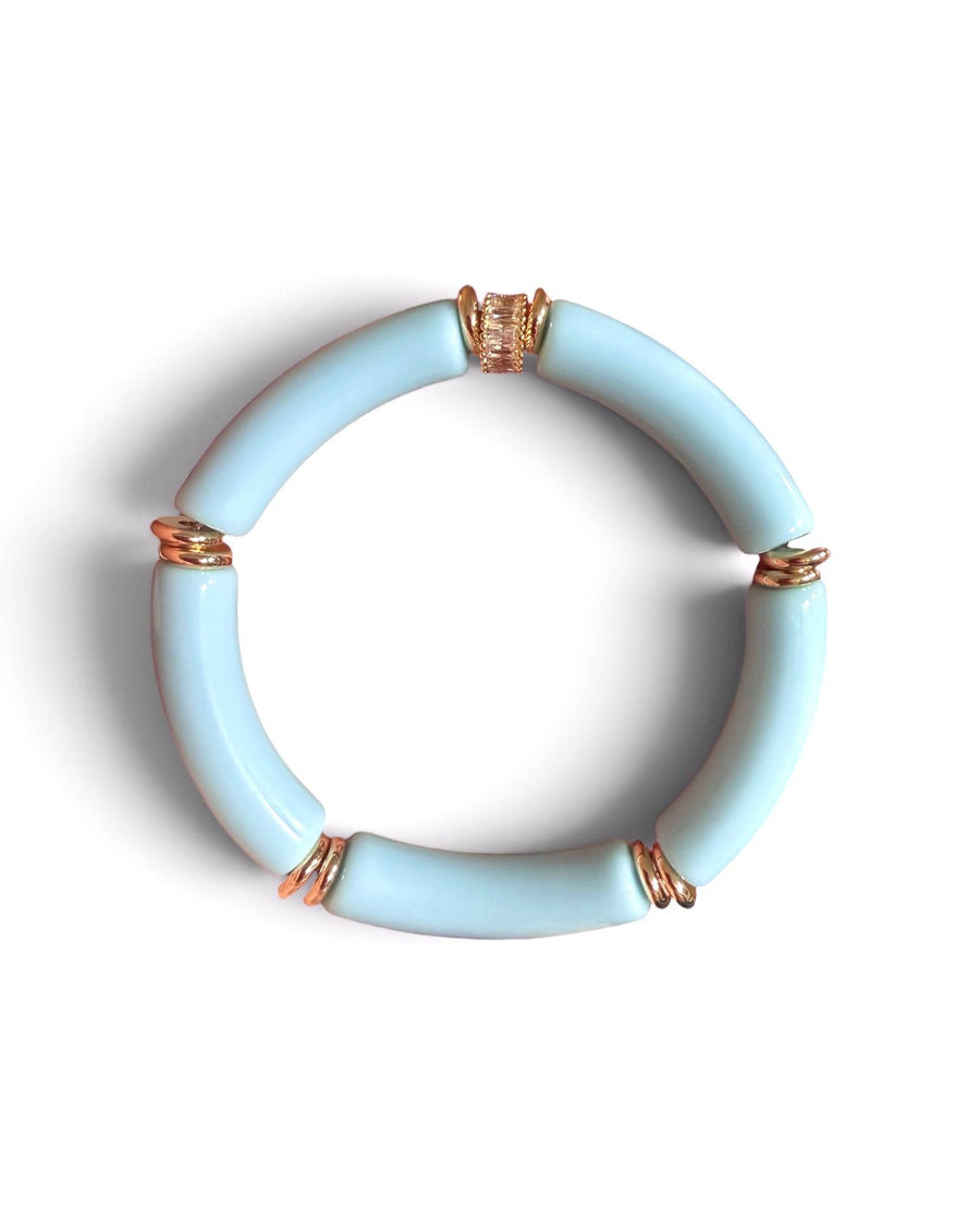 A light blue segmented bangle bracelet with small gold wire-wrapped accents, shown on a plain white background.