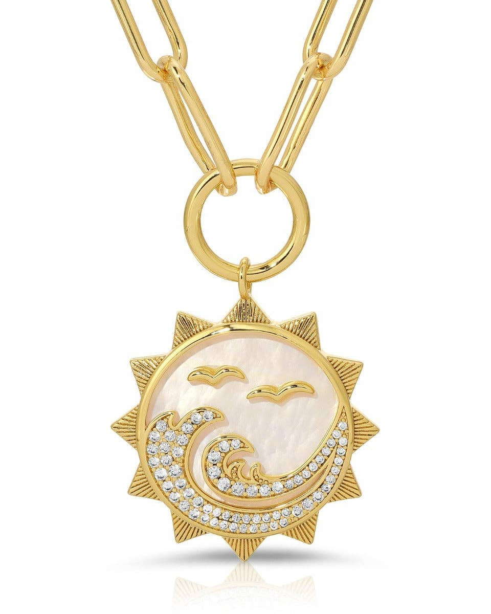 Gold necklace with a sun and wave pendant on a white background