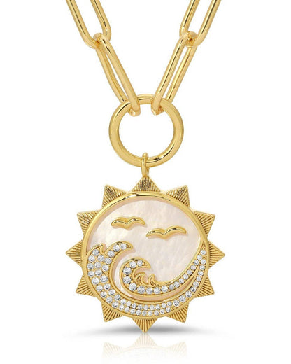 Gold necklace with a sun and wave pendant on a white background