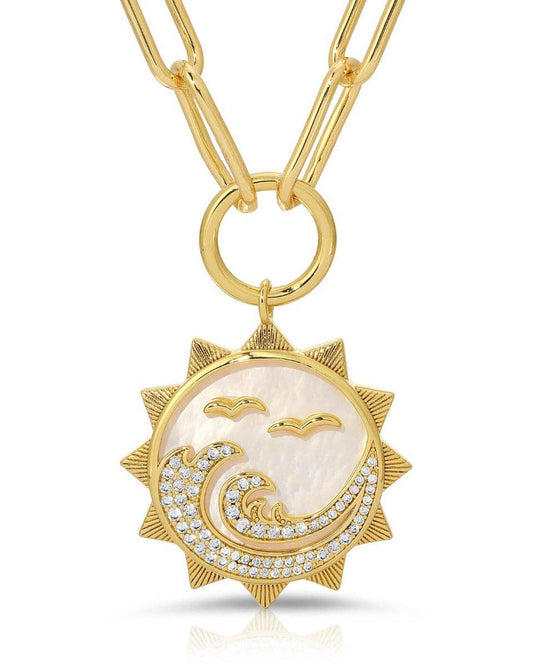 Gold necklace with a sun and wave pendant on a white background