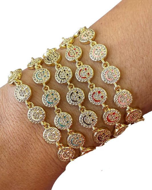 Gold bracelet with circular designs on a wrist against a white background