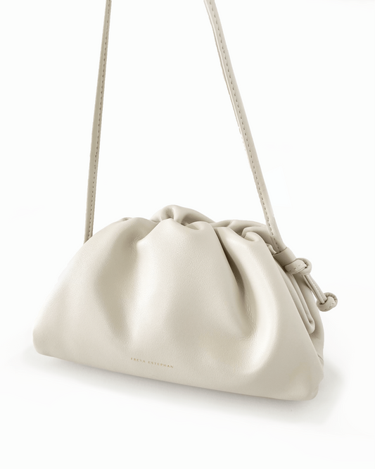 Beige handbag with a strap on a white background
