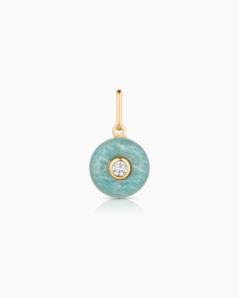 Turquoise pendant with gold chain on a white background