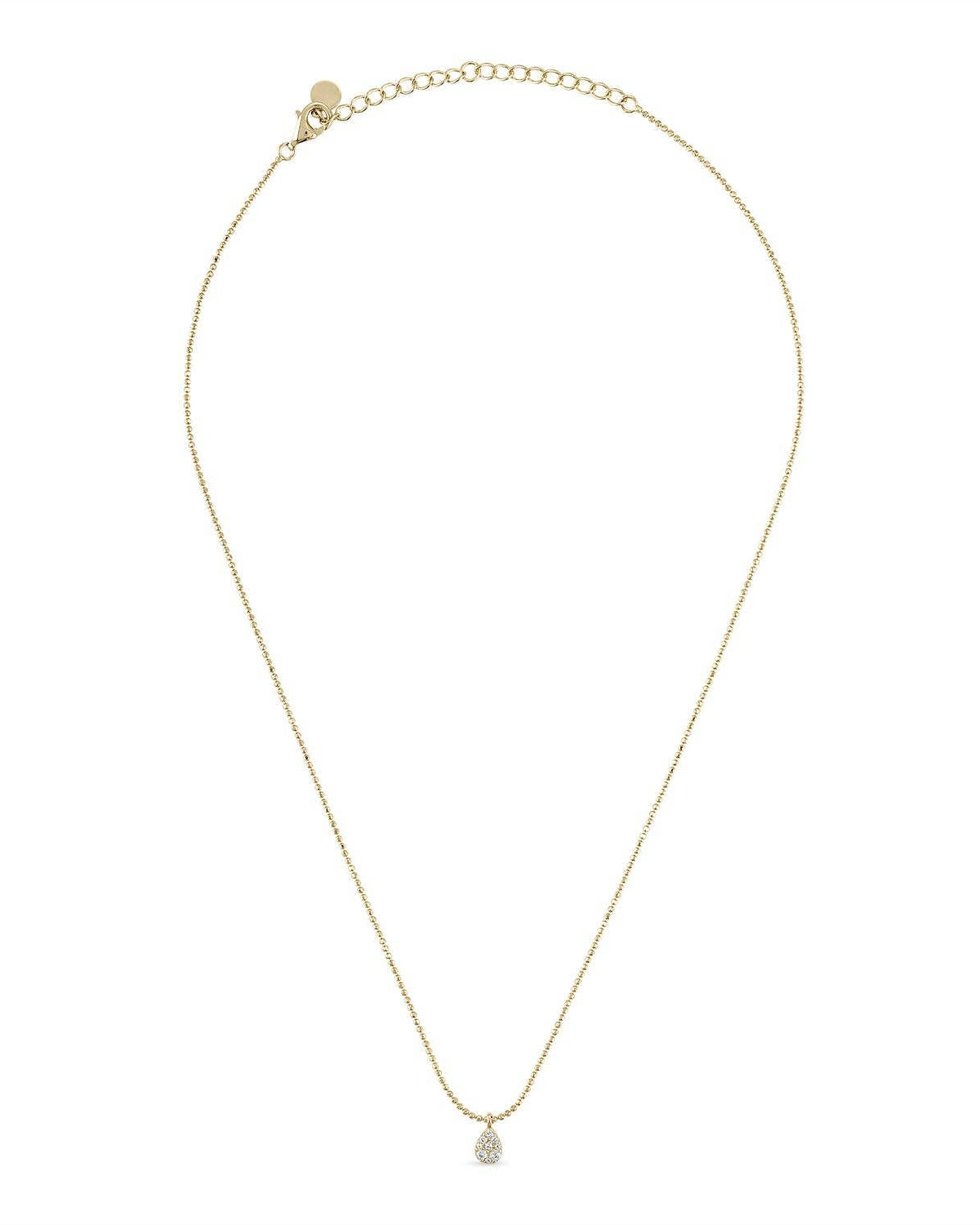 Gold necklace with a small pendant on a white background