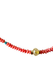 Necklace with red beads and a gold clasp on a white background