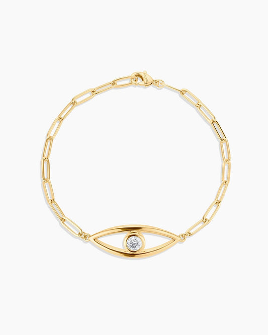 Gold bracelet with eye-shaped clasp on a white background