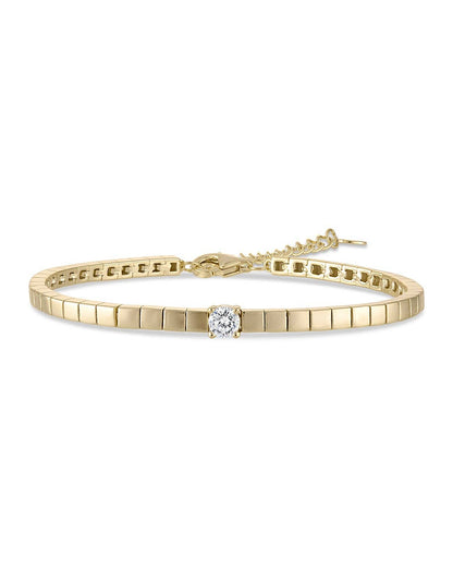 Gold bracelet with a diamond on a white background