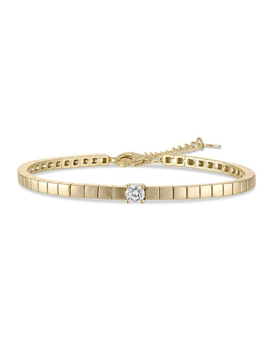 Gold bracelet with a diamond on a white background