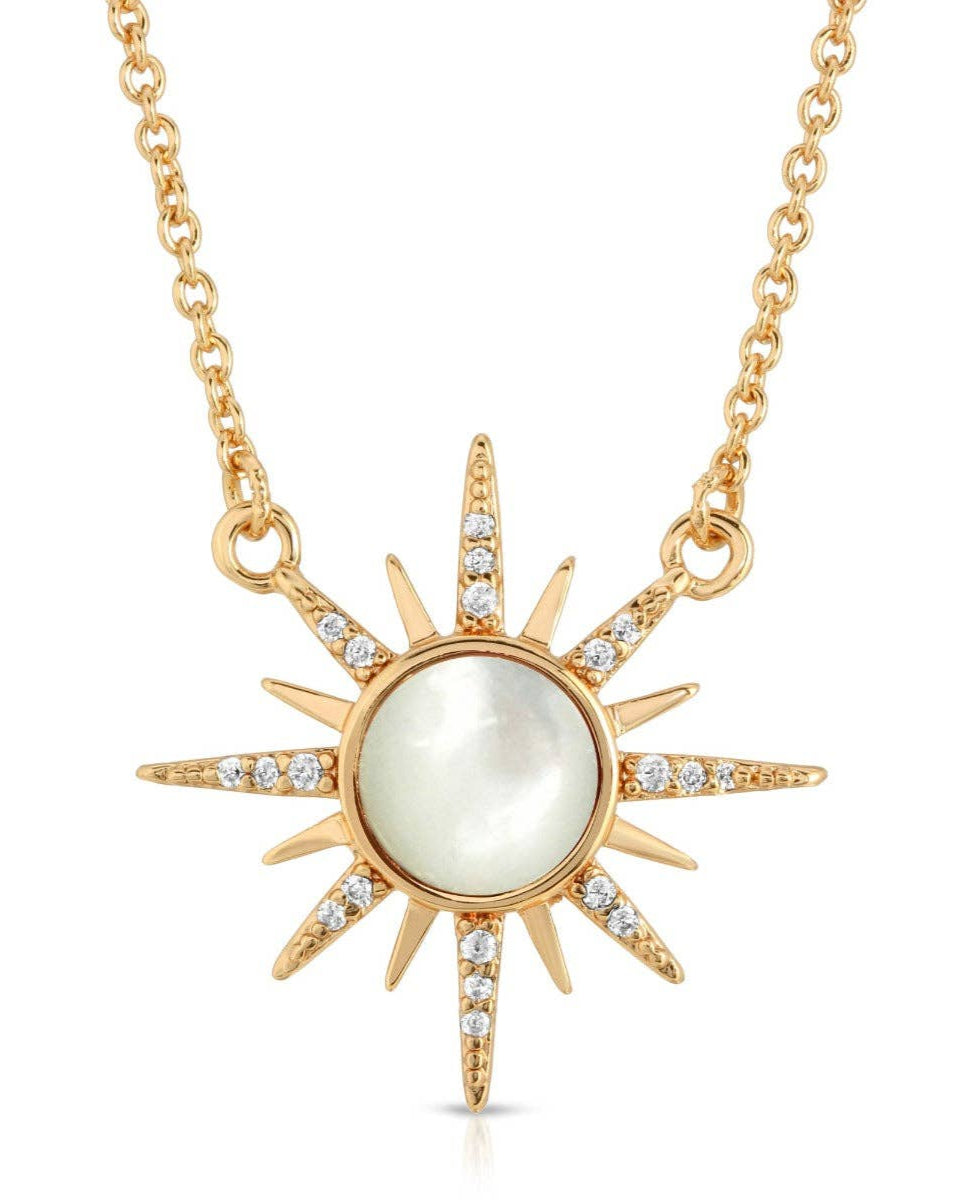 Shine with the ELIZABETH STONE Gem Starburst Necklace by Elizabeth Stone Jewelry, featuring a 14k gold-plated sunburst pendant with a luminous central pearl and sparkling stones.