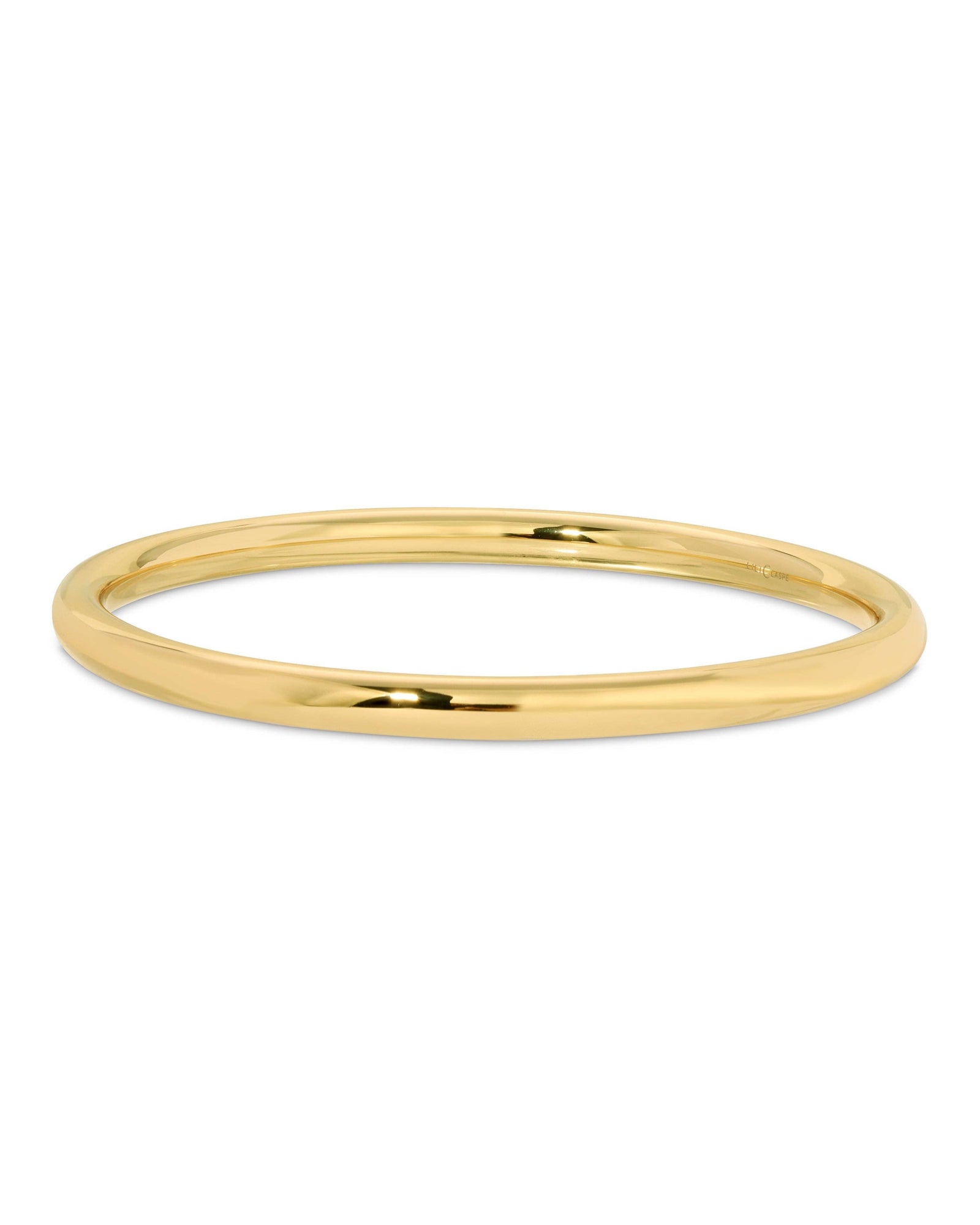A gold-plated brass hollow tube bangle bracelet with a polished finish.