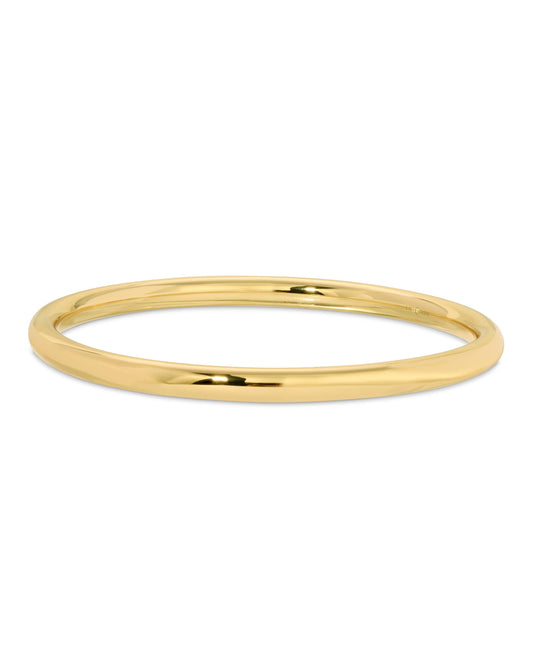 A gold-plated brass hollow tube bangle bracelet with a polished finish.