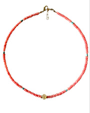 Necklace with red beads on a white background