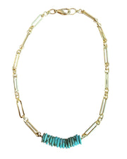 Gold necklace with turquoise beads on a white background
