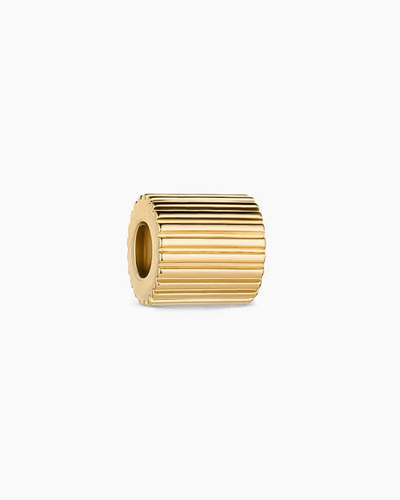 Gold cylindrical bead on a white background