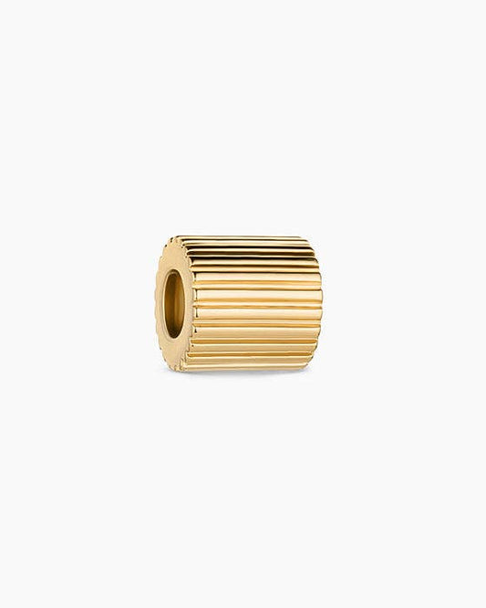Gold cylindrical bead on a white background
