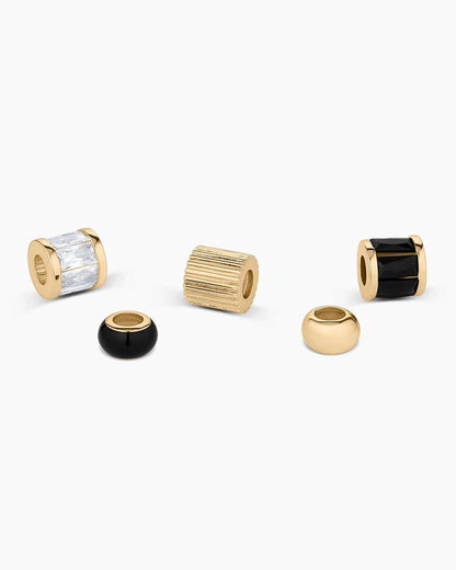 Set of gold and black beads on a white background