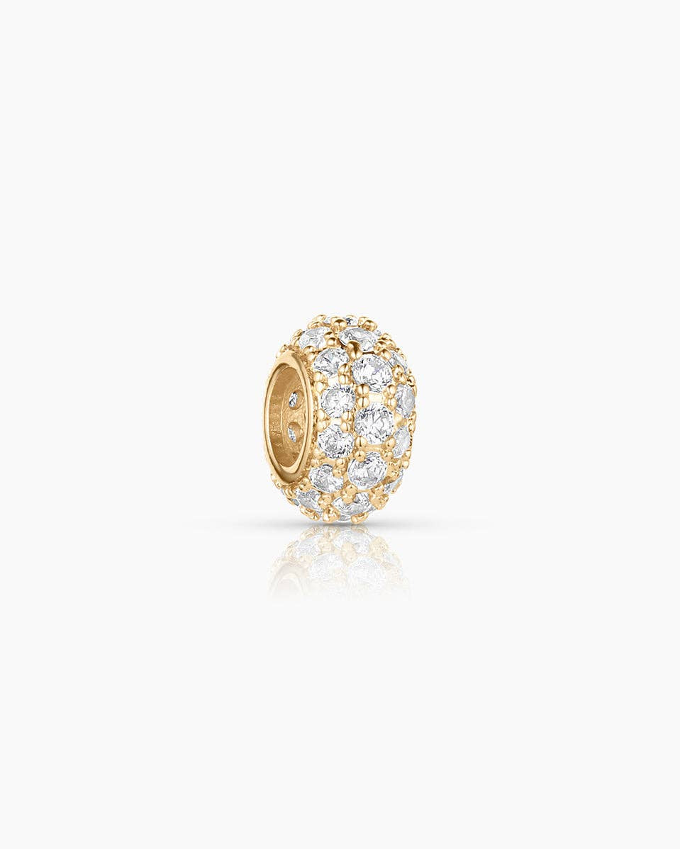 Gold earring with clear gemstones on a white background
