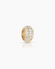 Gold earring with clear gemstones on a white background