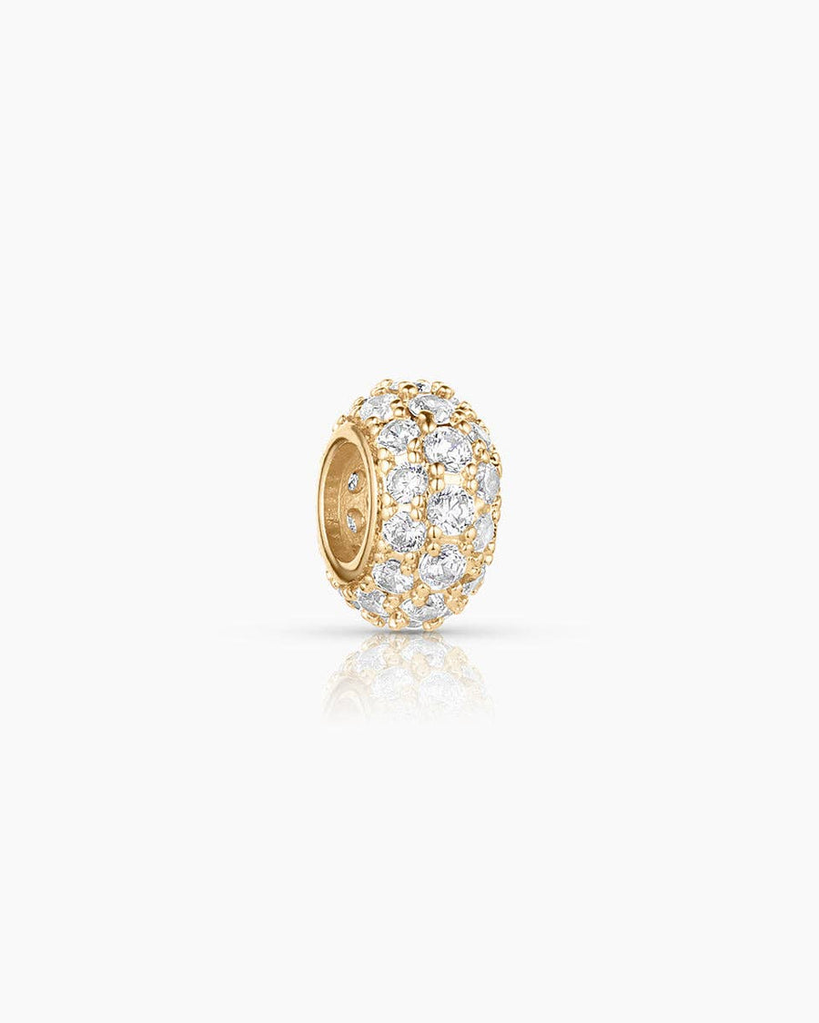 Gold earring with clear gemstones on a white background