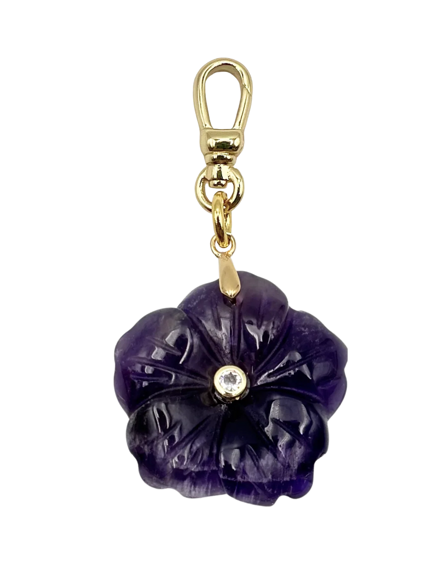 Purple flower-shaped keychain with gold accents on a white background
