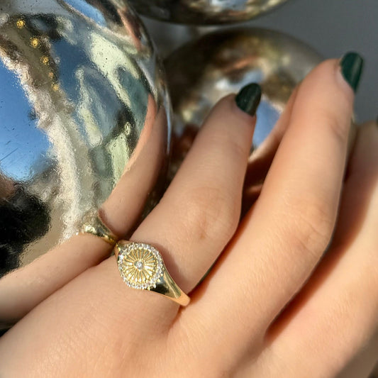 14kt yellow gold diamond pinky ring  diamond center fluted design with diamonds surrounding in a circle  @dylanjamesjewelry.com