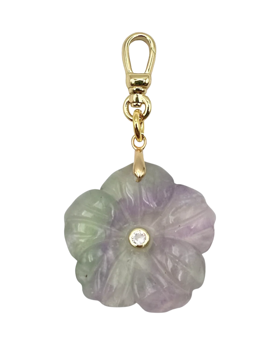 Flower-shaped jade pendant with gold clasp on a white background
