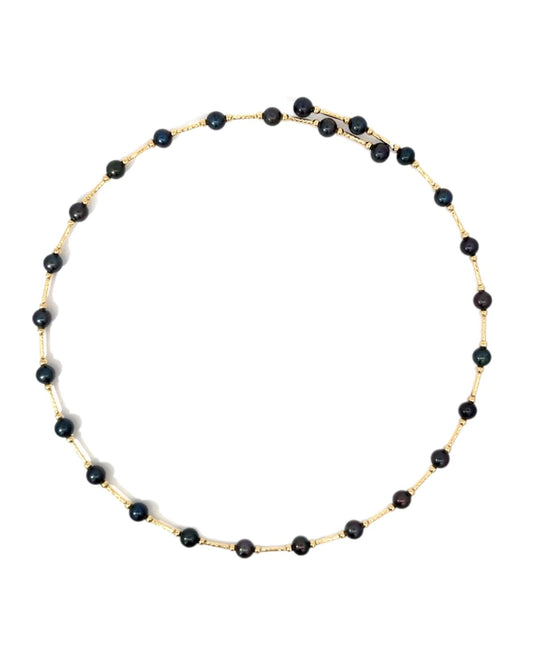 Necklace yellow gold with black pearls on a white background