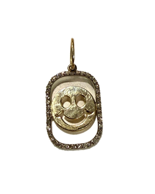 Gold pendant with a smiley face design on a white background