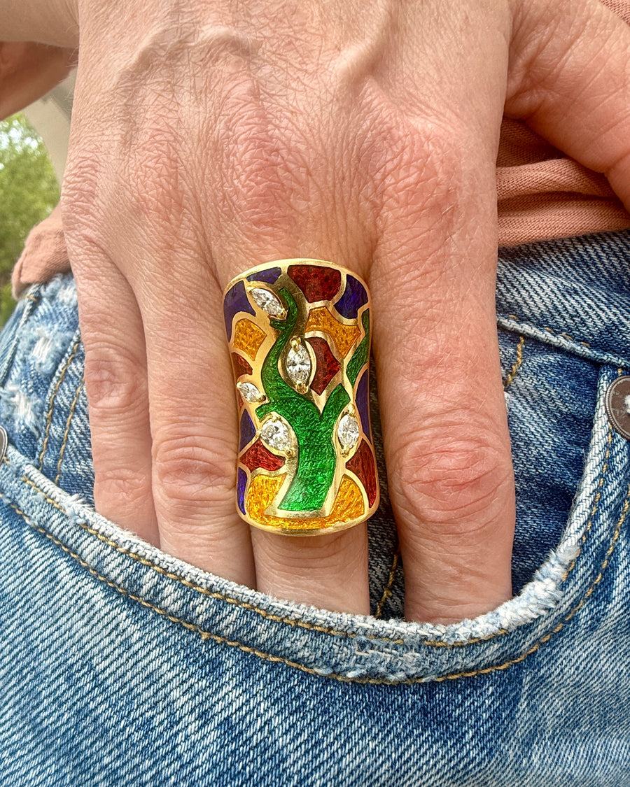 Colorful ring on a finger with a blurred background