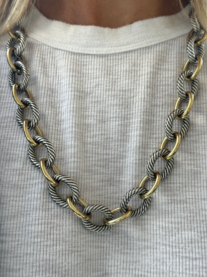 Necklace with gold and silver chain on a white shirt