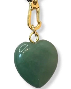 Green heart-shaped pendant with gold clasp on a white background