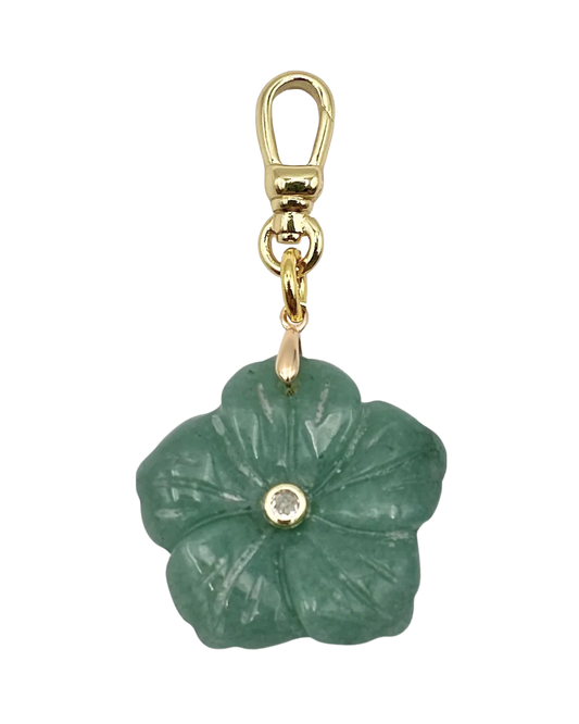 Green flower-shaped pendant with gold chain on a white background
