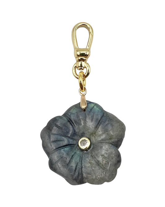 Floral-shaped keychain with gold clasp on a white background