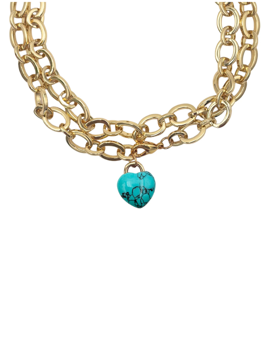 Gold chain necklace with a turquoise heart pendant on a white background