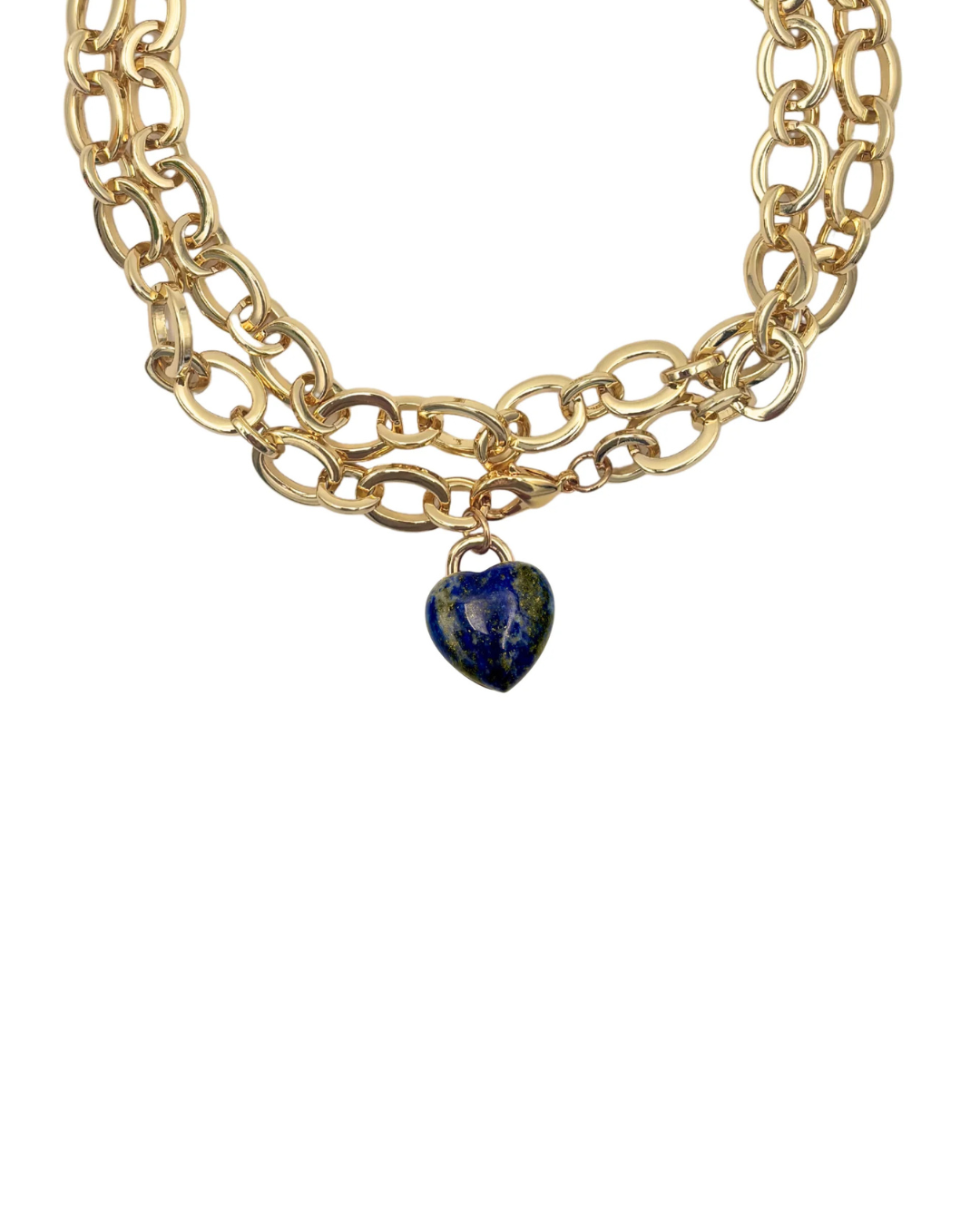 Gold chain necklace with a heart-shaped lapis lazuli pendant on a white background