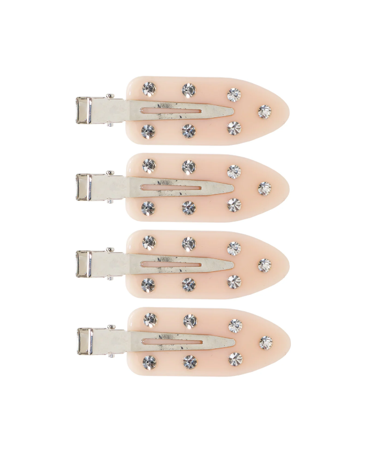 Set of four beige hair clips with decorative crystals on a white background