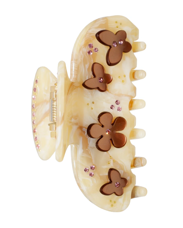 Beige hair clip with butterfly designs on a white background