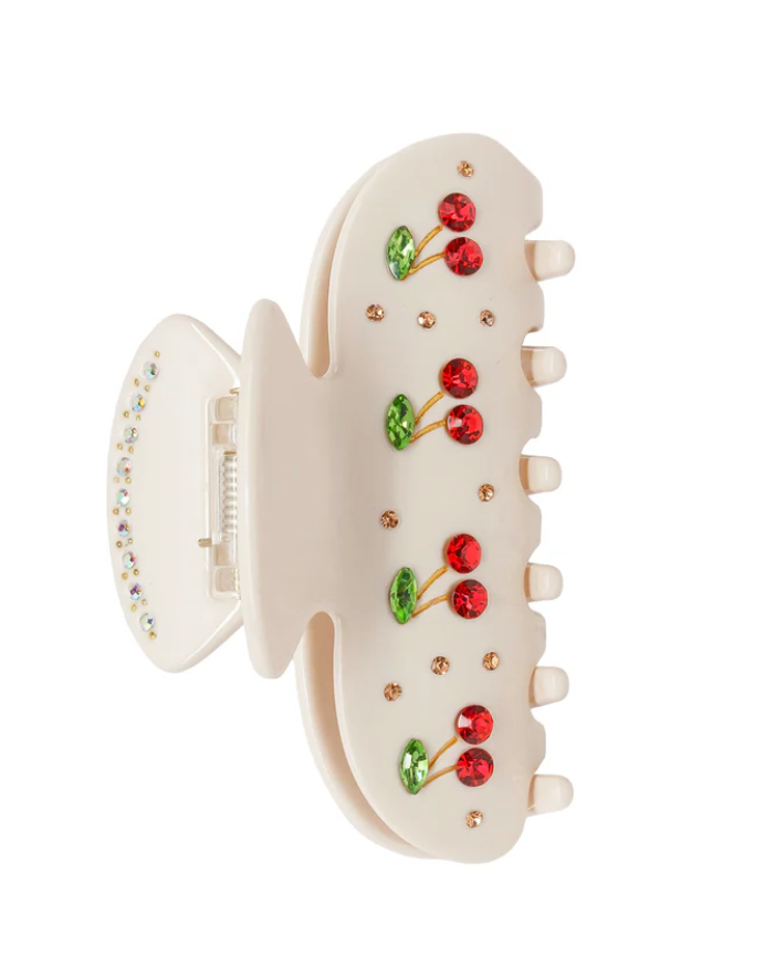 White hair clip with cherry design on a white background