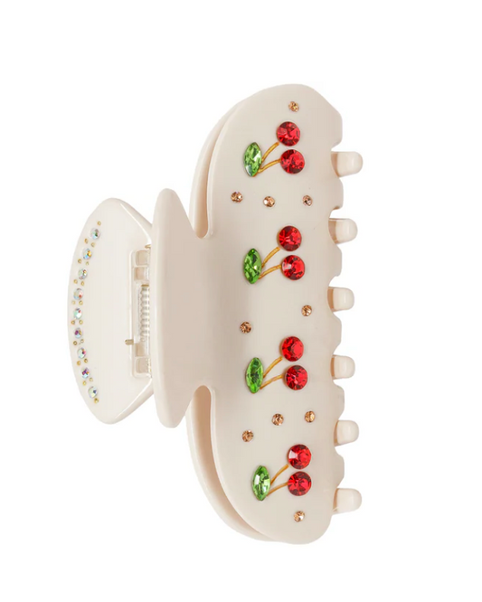 White hair clip with cherry design on a white background